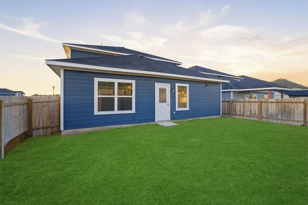 a front view of a house with yard and deck