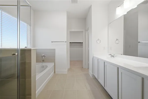 a bathroom with a tub sink and mirror