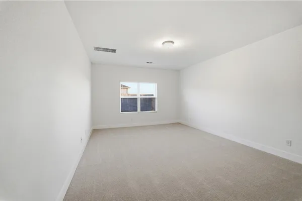 a view of an empty room with a ceiling fan