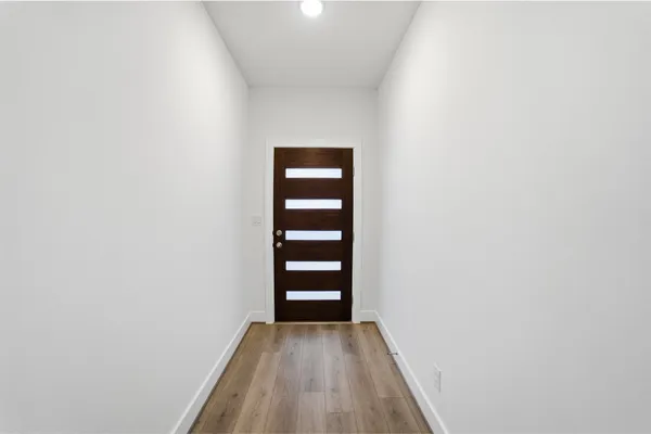 a view of a room with wooden floor