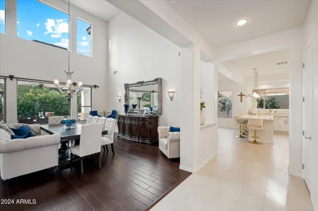 a kitchen with a sink a stove a refrigerator and white cabinets