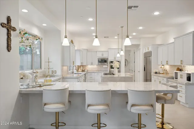 a living room with furniture large window and wooden floor