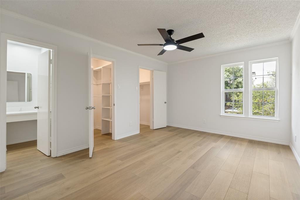 5300 Keller Springs Road, Unit 2042 Dallas, TX 75248 - Photo 18 of 28 Spacious room featuring wood-finish flooring, white walls, and crown molding