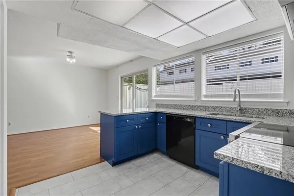 a kitchen with stainless steel appliances granite countertop wooden cabinets and a sink