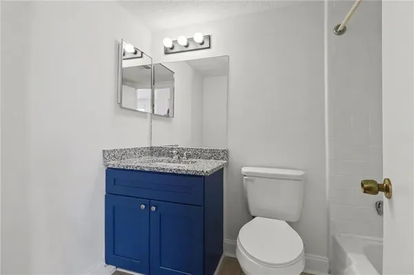 a bathroom with a sink a toilet and mirror