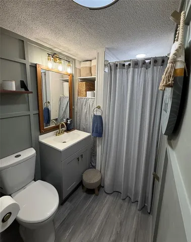 a bathroom with a toilet a sink and a mirror
