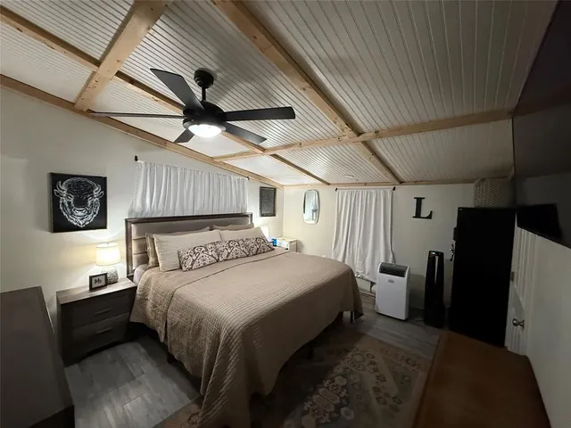a bedroom with a bed and a refrigerator