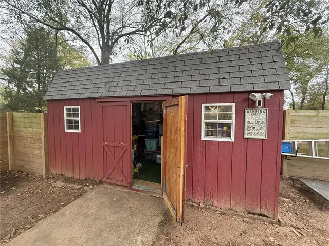 a view of a house with a door and wooden walls