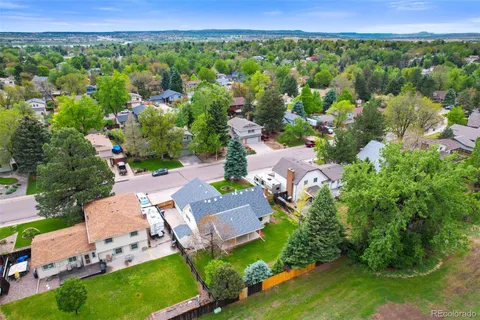 an aerial view of a house with garden space and street view