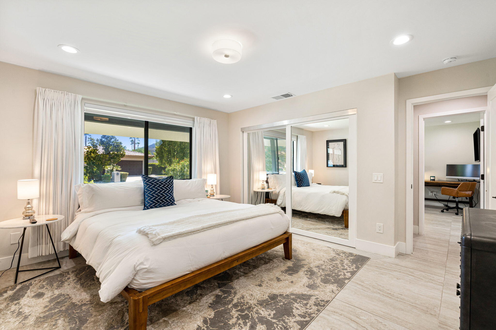 45655 Apache Road, Unit D Indian Wells, CA 92210 - Photo 23 of 31 a bedroom with a large bed and a large window