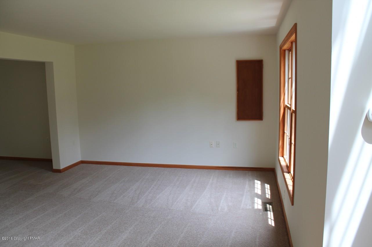 161 Granite Road Long Pond, PA 18334 - Photo 3 of 14 an empty room with wooden floor and windows