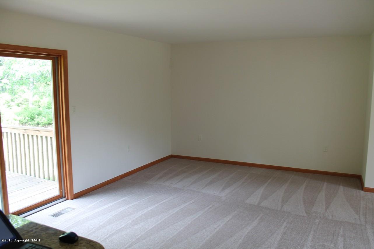 161 Granite Road Long Pond, PA 18334 - Photo 5 of 14 an empty room with wooden floor and windows