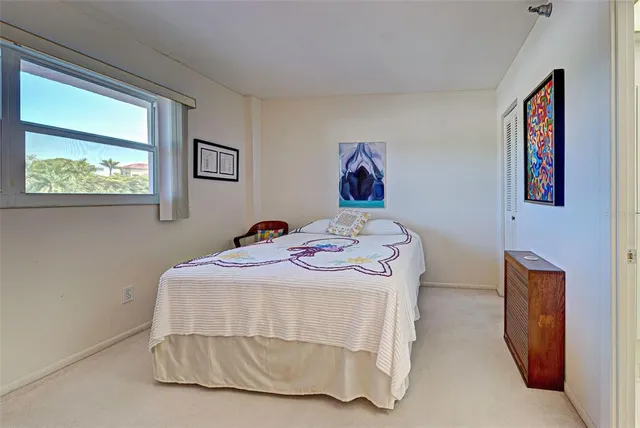 a bedroom with a bed and a painting on the wall