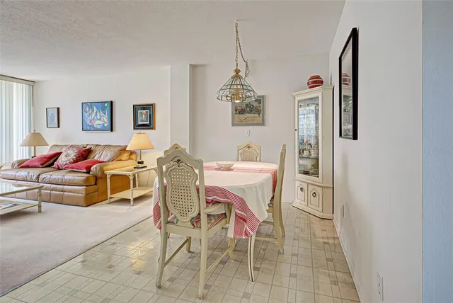 a dining room with furniture and a chandelier
