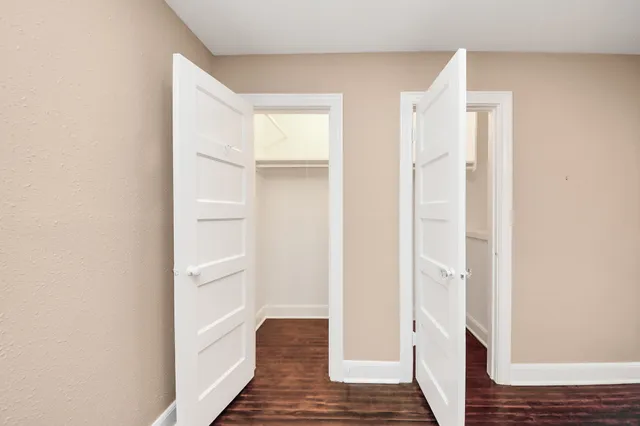 a view of a hallway with wooden floor and entryway