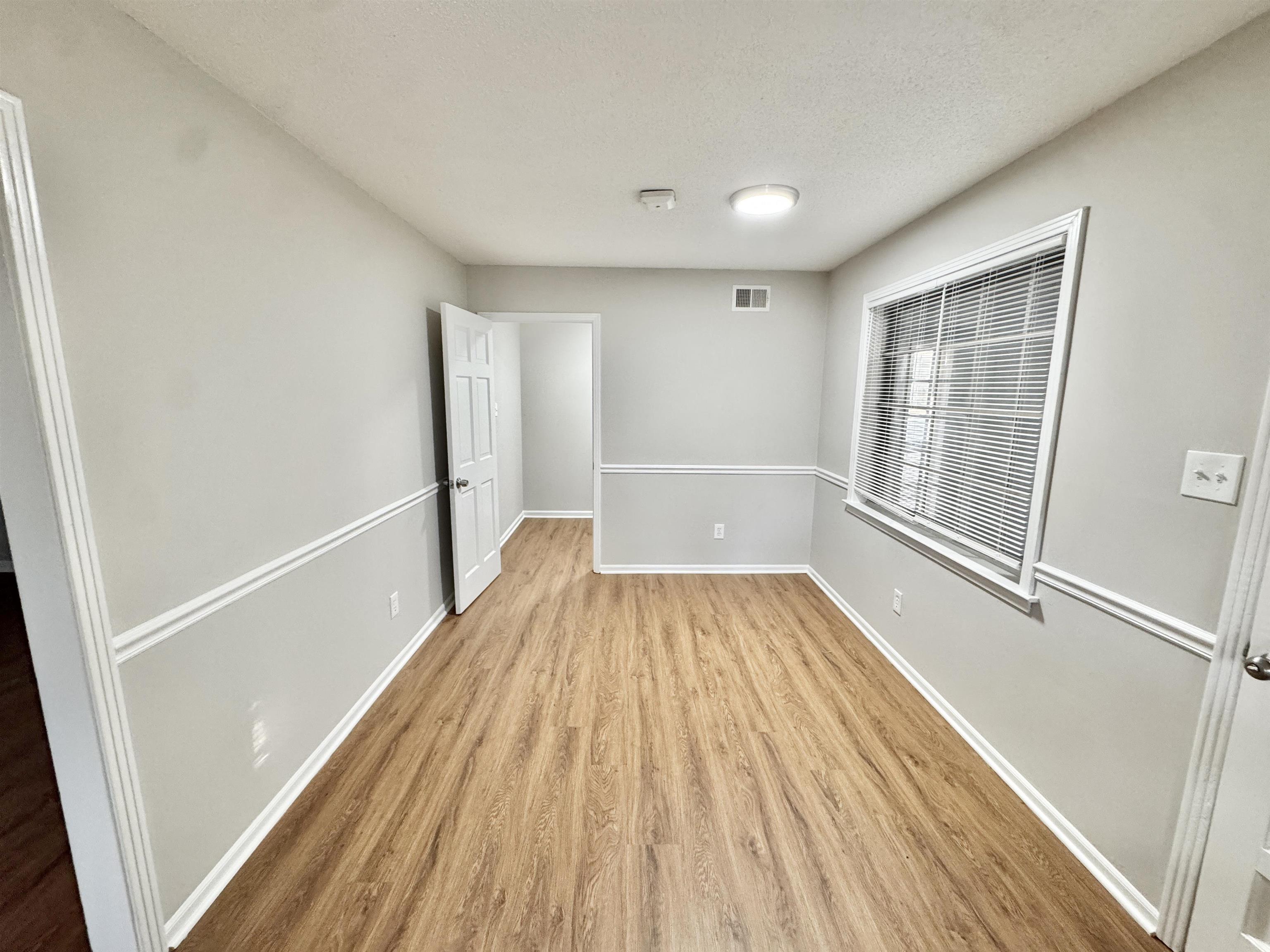 3334 Snow Ridge Cove Memphis, TN 38115 - Photo 15 of 38 Unfurnished room with a textured ceiling and light wood-style floors