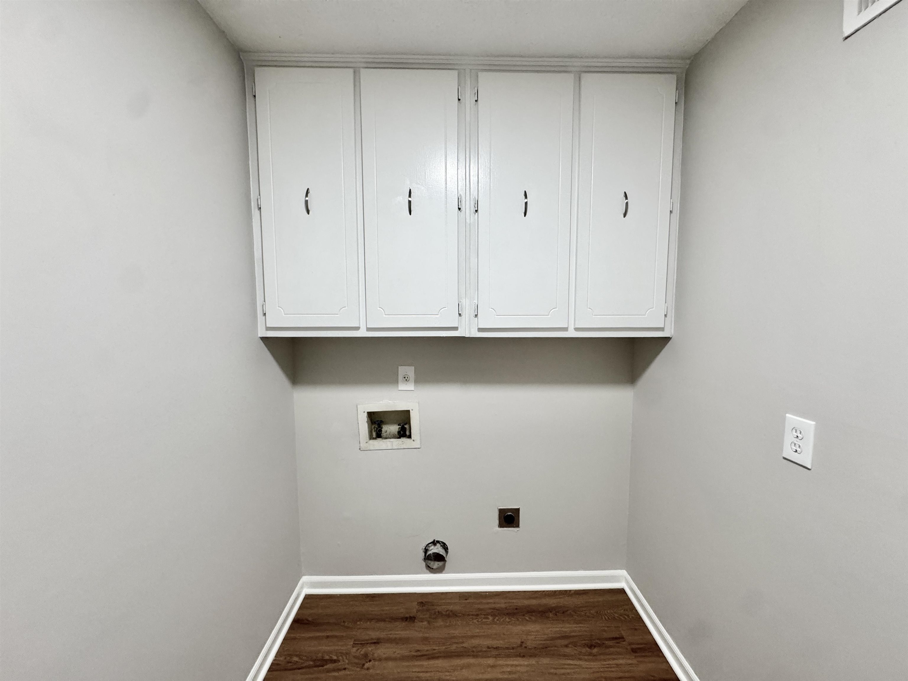 3334 Snow Ridge Cove Memphis, TN 38115 - Photo 29 of 38 Laundry area with dark wood-type flooring, washer hookup, cabinet space, and hookup for an electric dryer