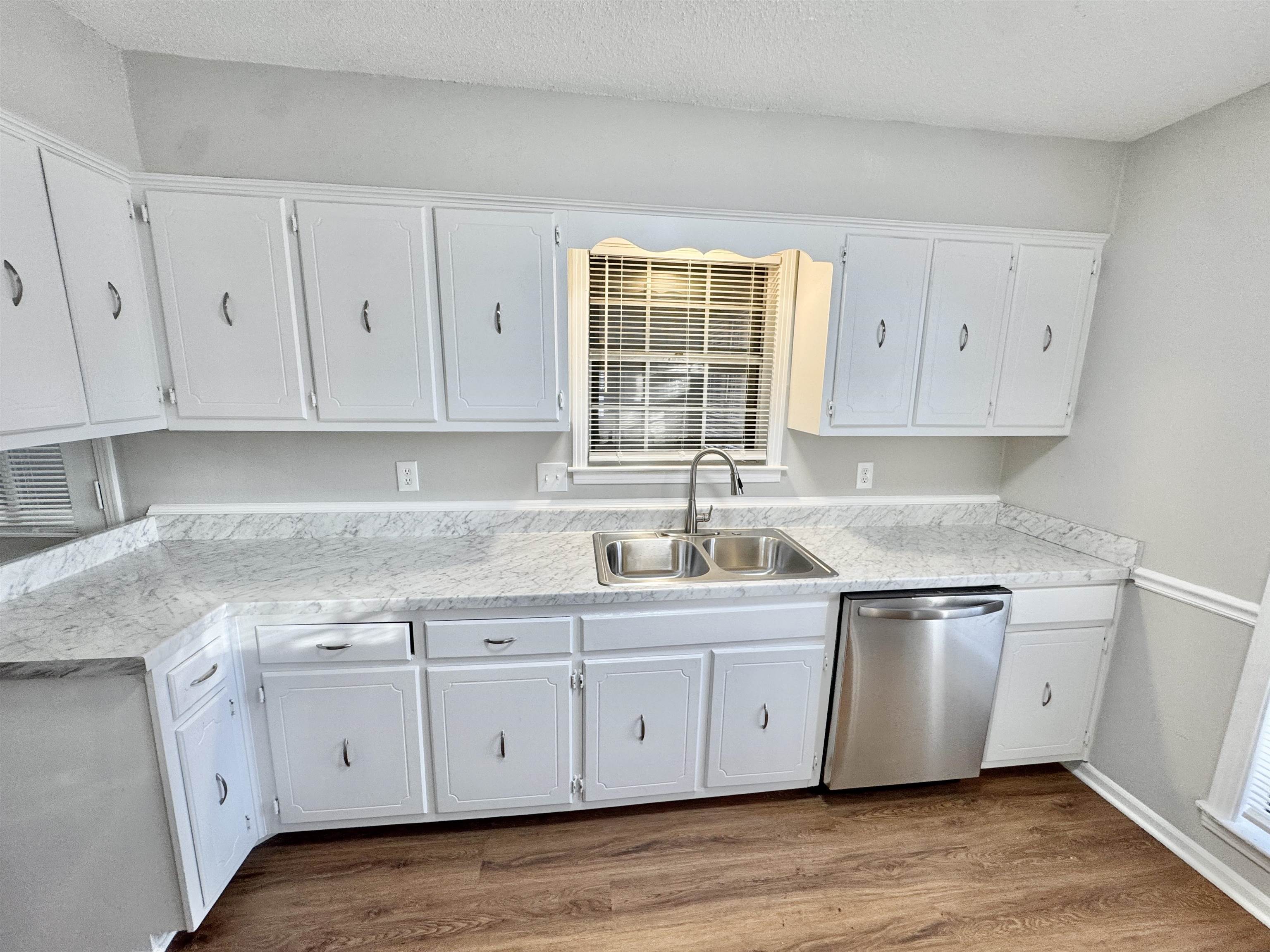 3334 Snow Ridge Cove Memphis, TN 38115 - Photo 2 of 38 a kitchen with stainless steel appliances granite countertop a sink and dishwasher wooden cabinets