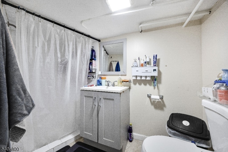 383 Broadway Passaic, NJ 07055 - Photo 8 of 11 a bathroom with a sink toilet and shower