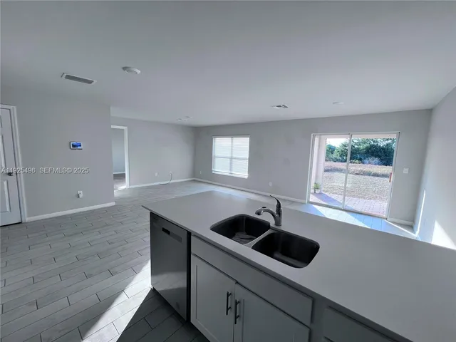 a kitchen that has a sink and a stove