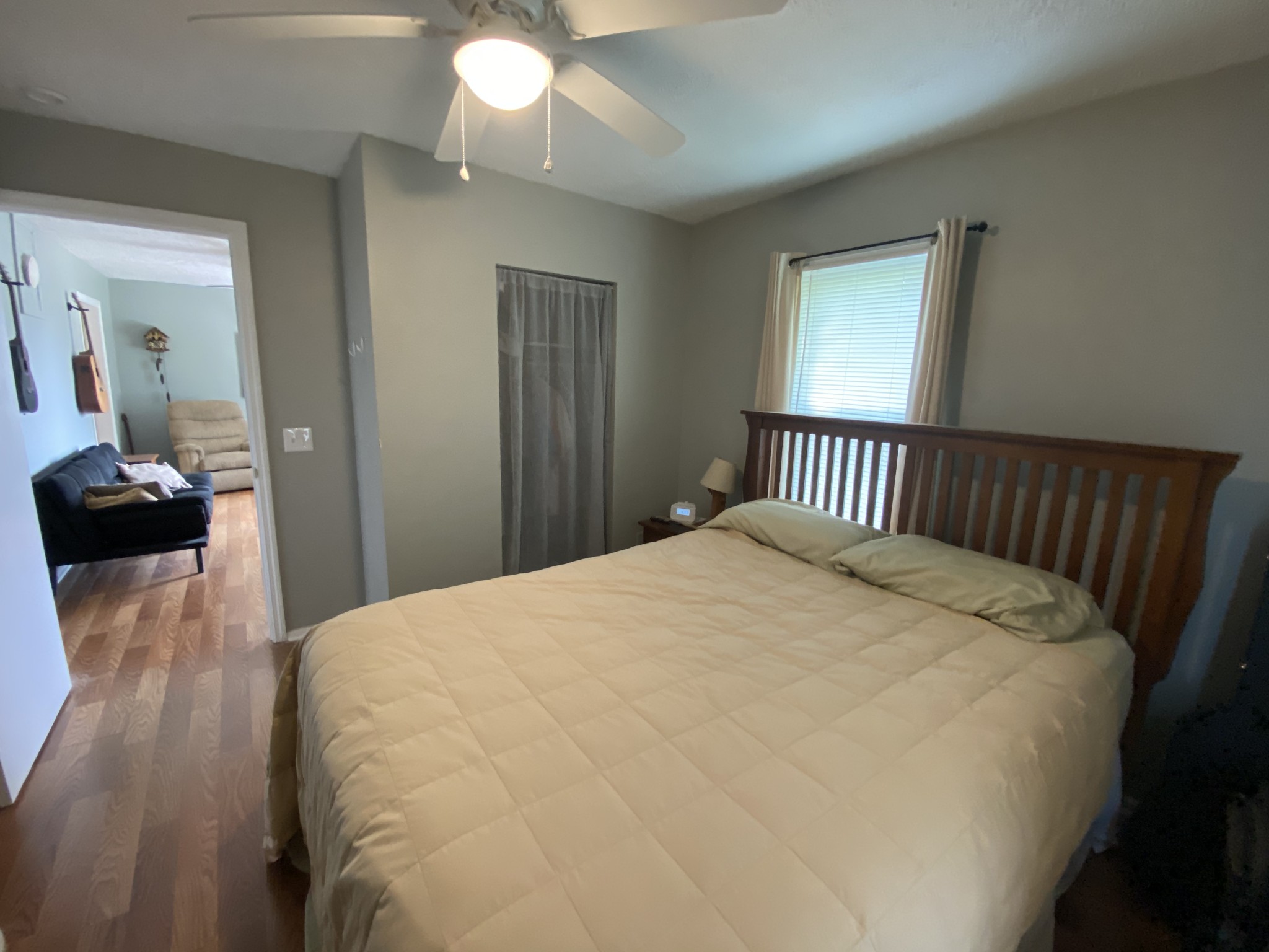 3128 Academy Road Portland, TN 37148 - Photo 8 of 27 a large white bed in a bedroom next to a window and a chandelier