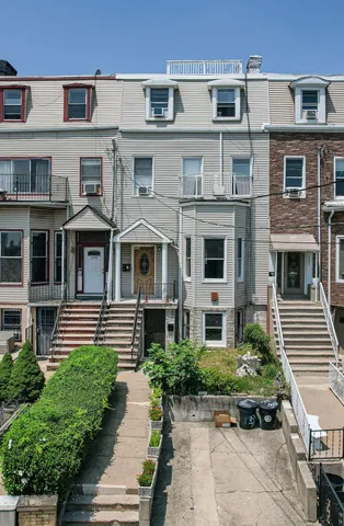 a front view of a building with garden