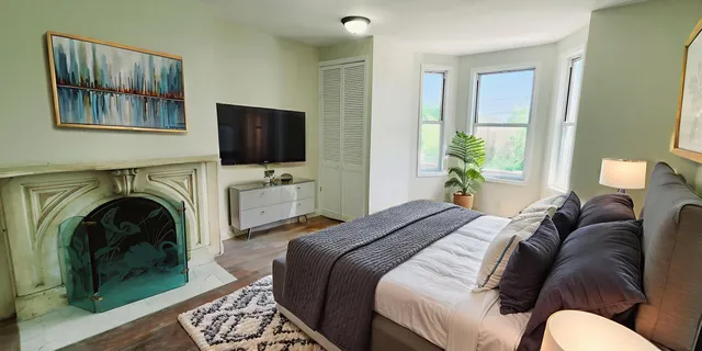 a bedroom with a bed and a flat screen tv
