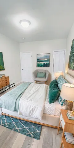 a bedroom with a bed and a window