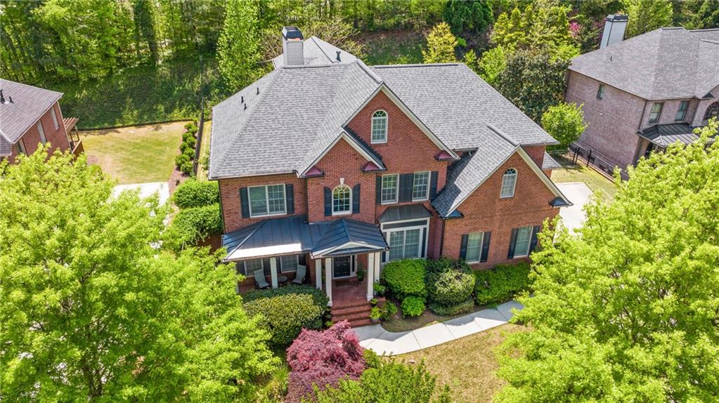 a aerial view of a house with a yard and potted plants