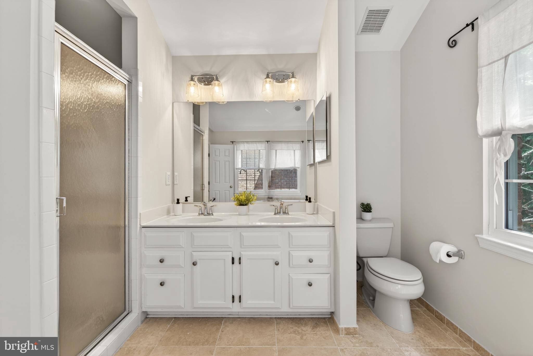 1409 Park Garden Lane Reston, VA 20194 - Photo 23 of 41 a bathroom with a granite countertop sink toilet a large mirror a vanity and