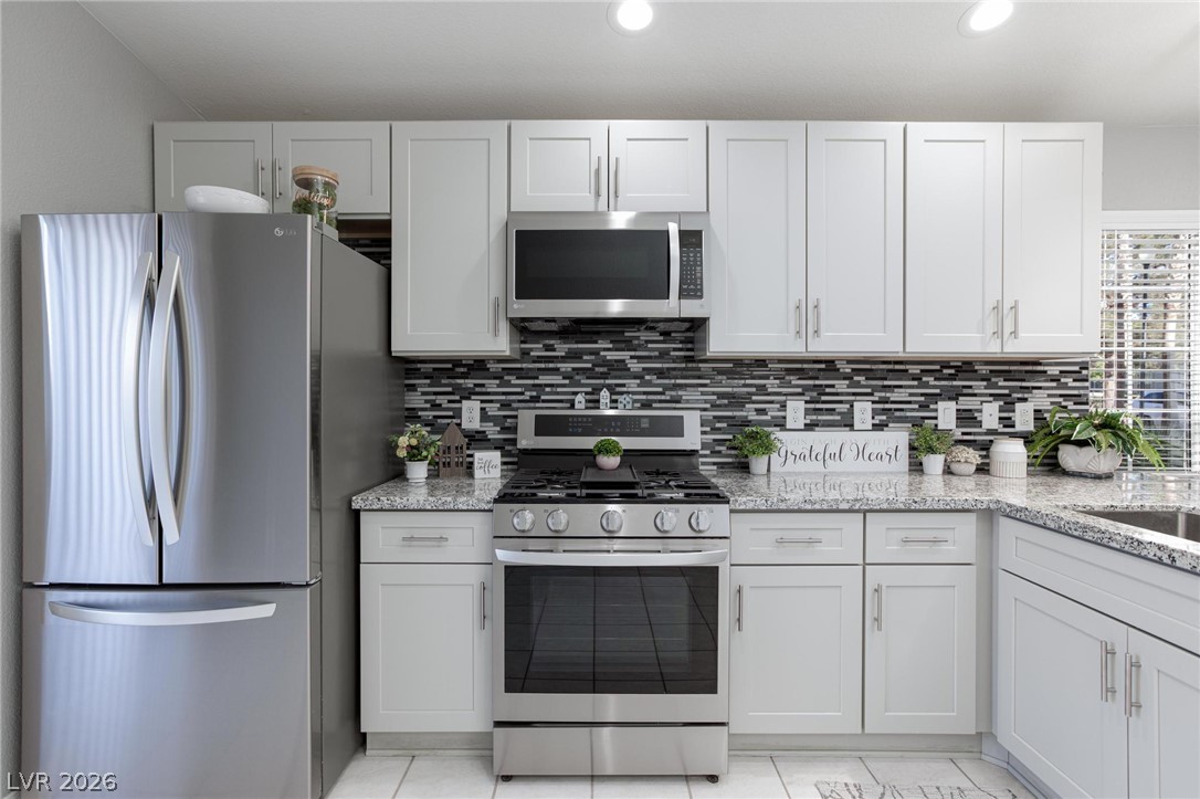2254 Ramsgate Drive Henderson, NV 89074 - Photo 10 of 43 Culinary delights await in this bright kitchen with ample counter space and modern appliances.