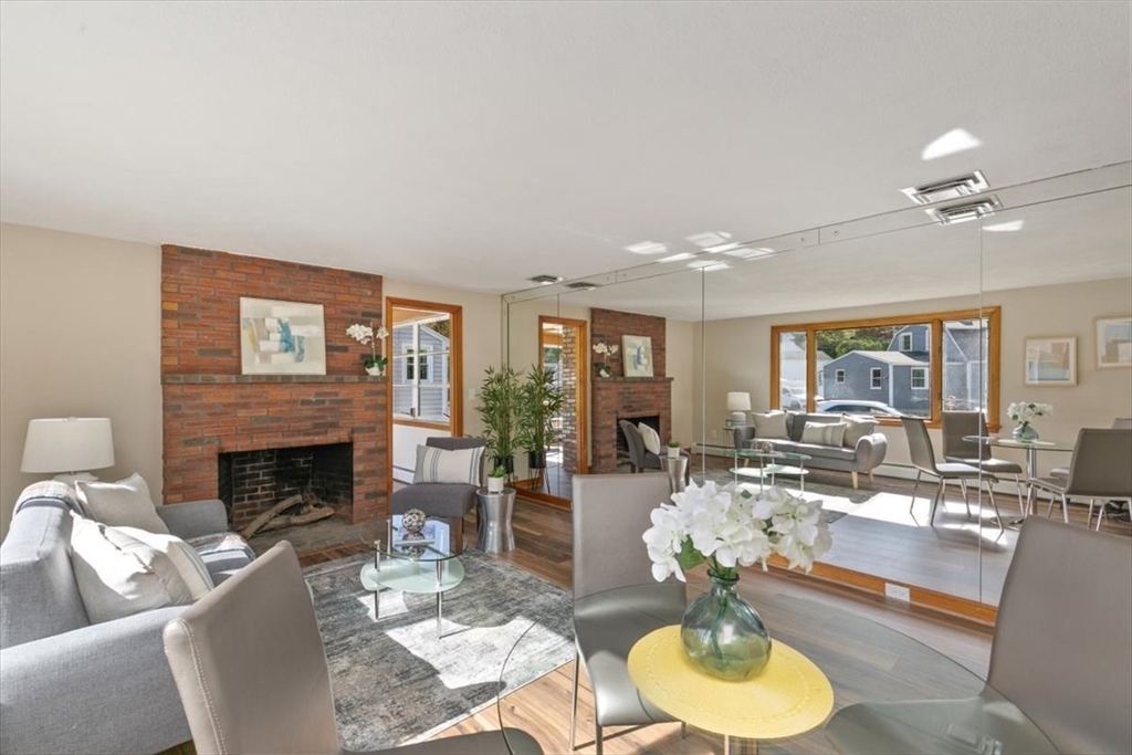 270 Lowell Street Wakefield, MA 01880 - Photo 12 of 41 a living room with fireplace furniture and a large window