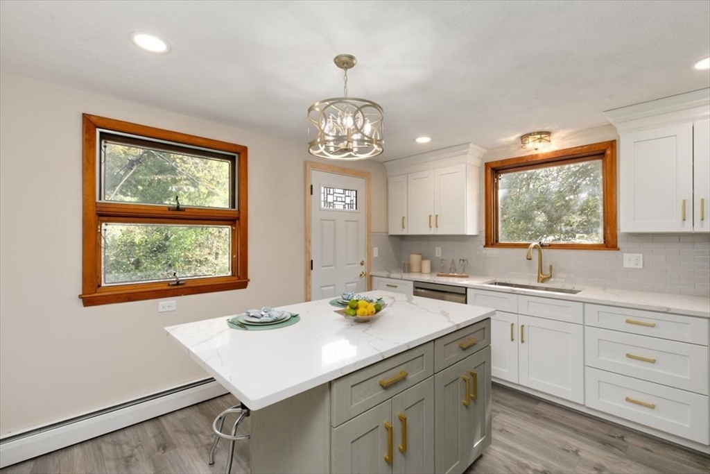 270 Lowell Street Wakefield, MA 01880 - Photo 14 of 41 a kitchen with a sink a window and chairs