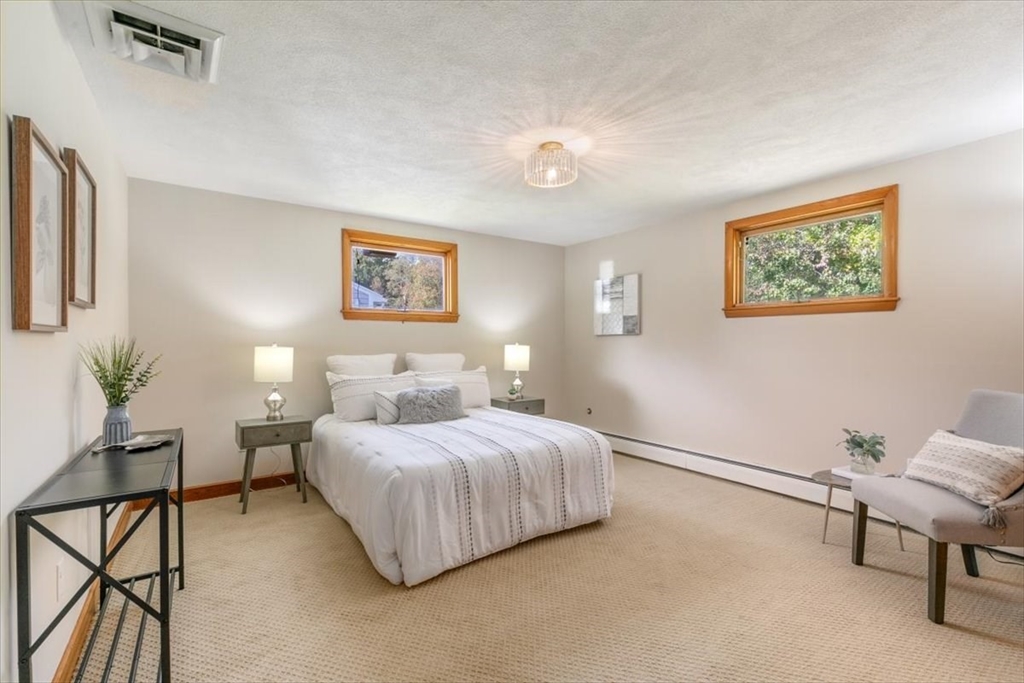 270 Lowell Street Wakefield, MA 01880 - Photo 19 of 41 a bedroom with a bed and a painting on the wall