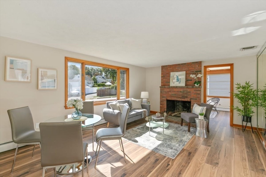 270 Lowell Street Wakefield, MA 01880 - Photo 2 of 41 a living room with furniture a fireplace and a potted plant