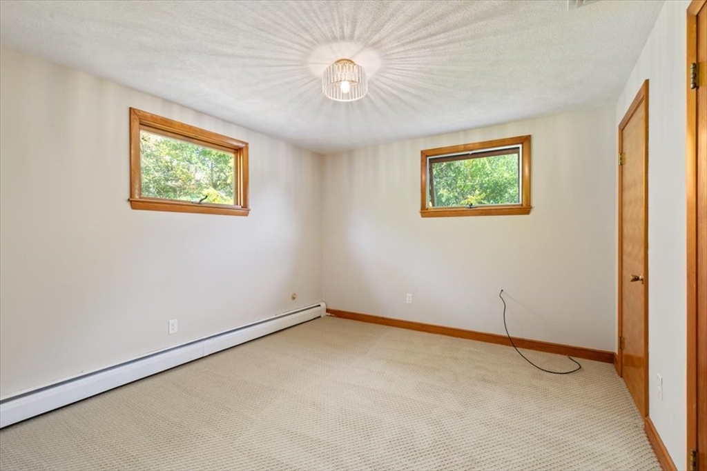 270 Lowell Street Wakefield, MA 01880 - Photo 21 of 41 an empty room with windows and fan
