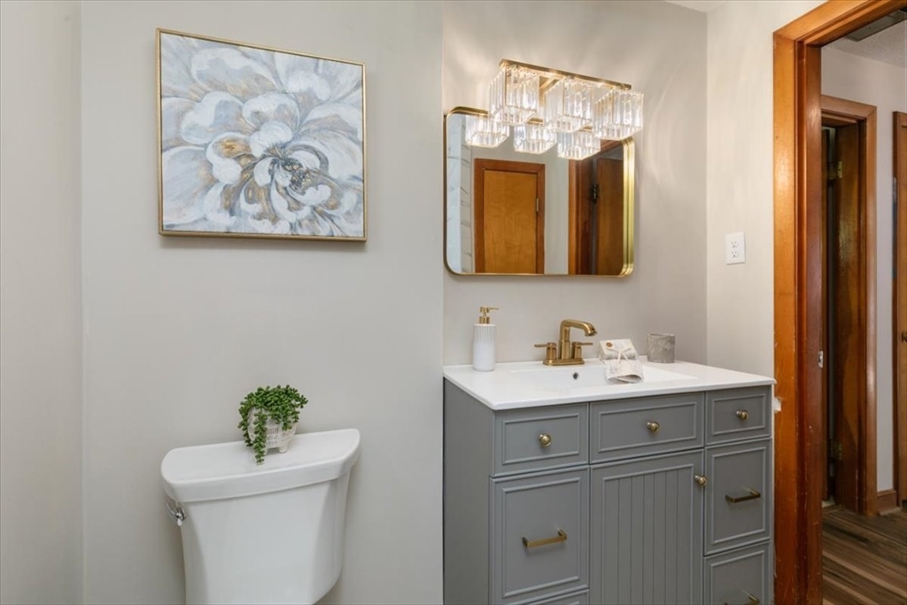 270 Lowell Street Wakefield, MA 01880 - Photo 25 of 41 a bathroom with a toilet a sink and a mirror