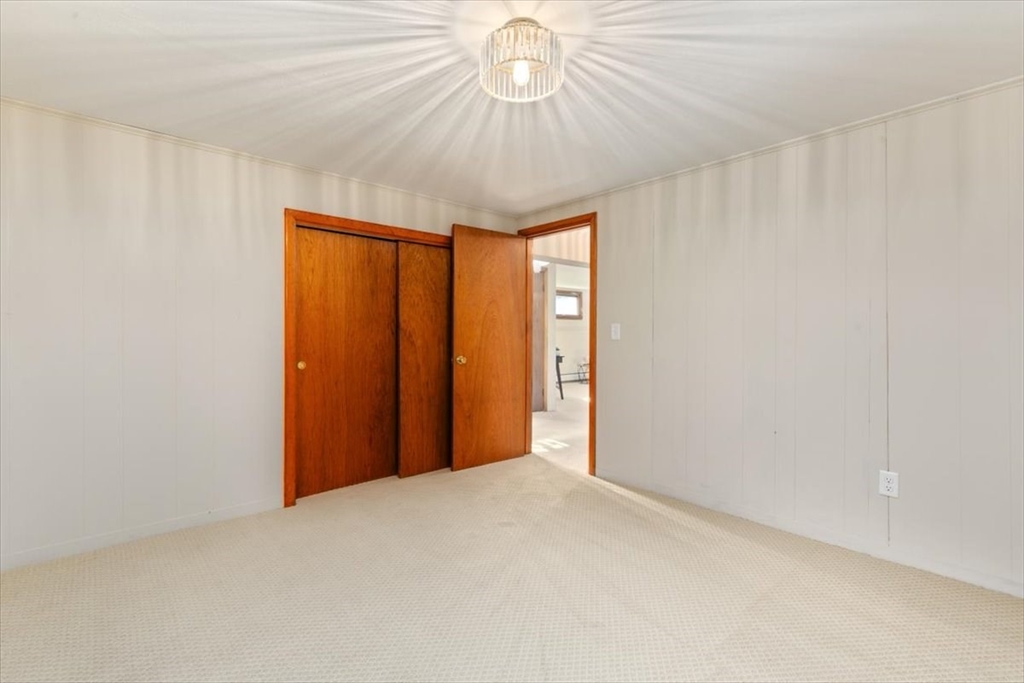 270 Lowell Street Wakefield, MA 01880 - Photo 35 of 41 a very nice looking room with a chandelier fan and a window