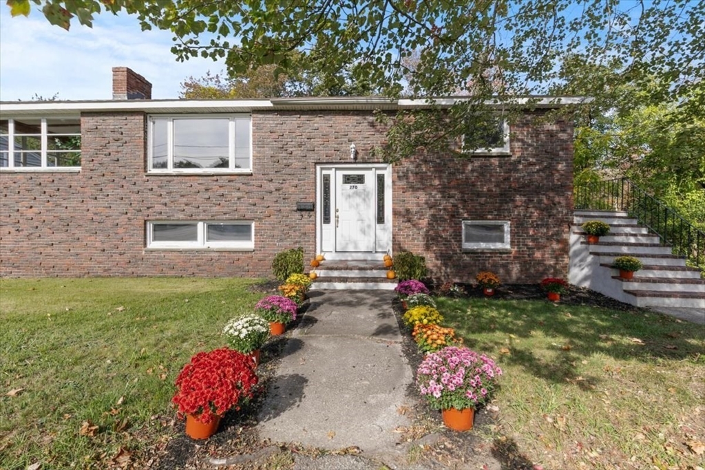 270 Lowell Street Wakefield, MA 01880 - Photo 4 of 41 a front view of a house with garden