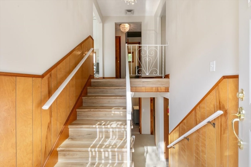 270 Lowell Street Wakefield, MA 01880 - Photo 7 of 41 a view of a hallway with wooden floor and staircase