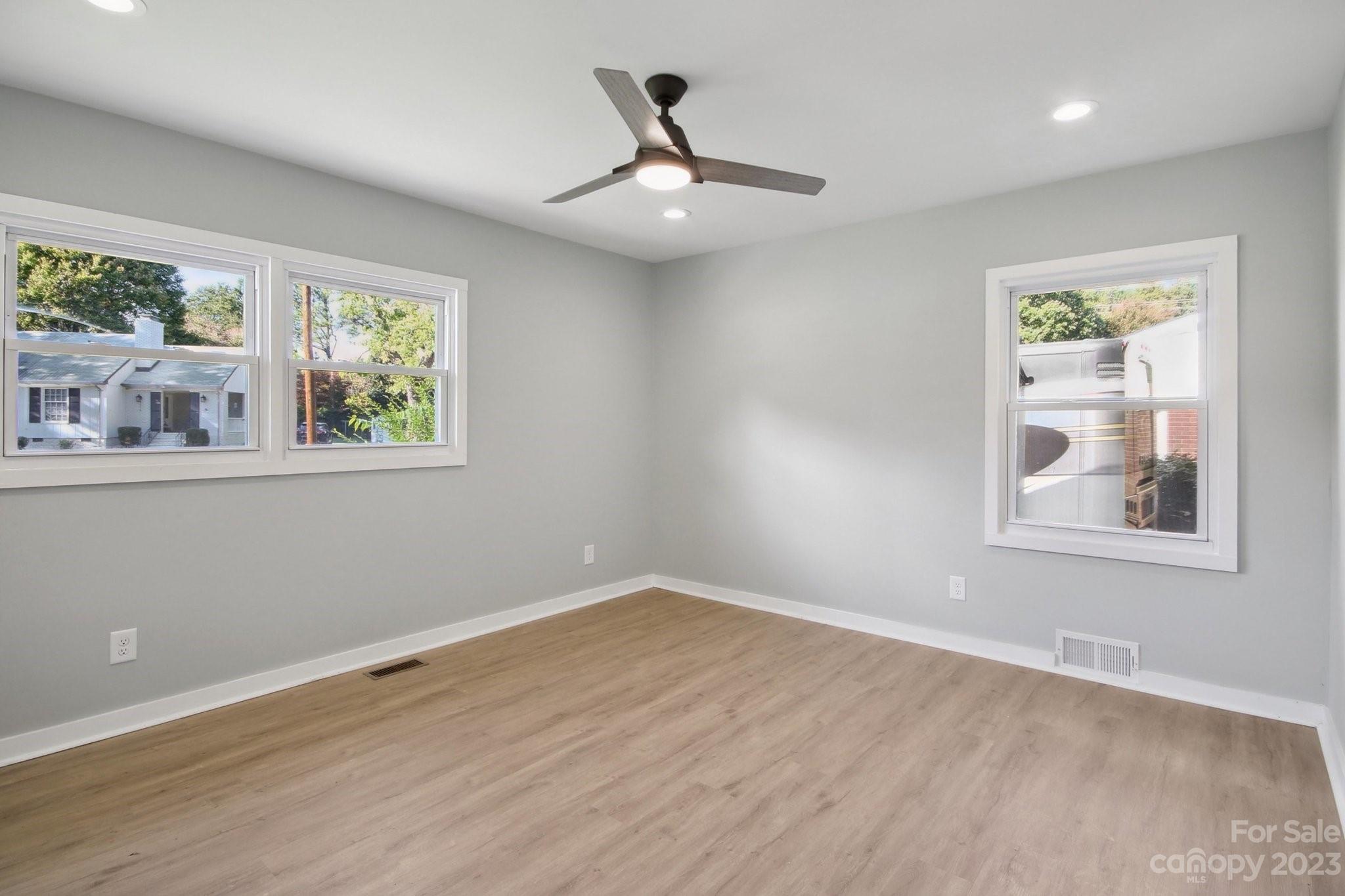 5225 Farmbrook Drive Charlotte, NC 28210 - Photo 14 of 18 a view of empty room with wooden floor and fan