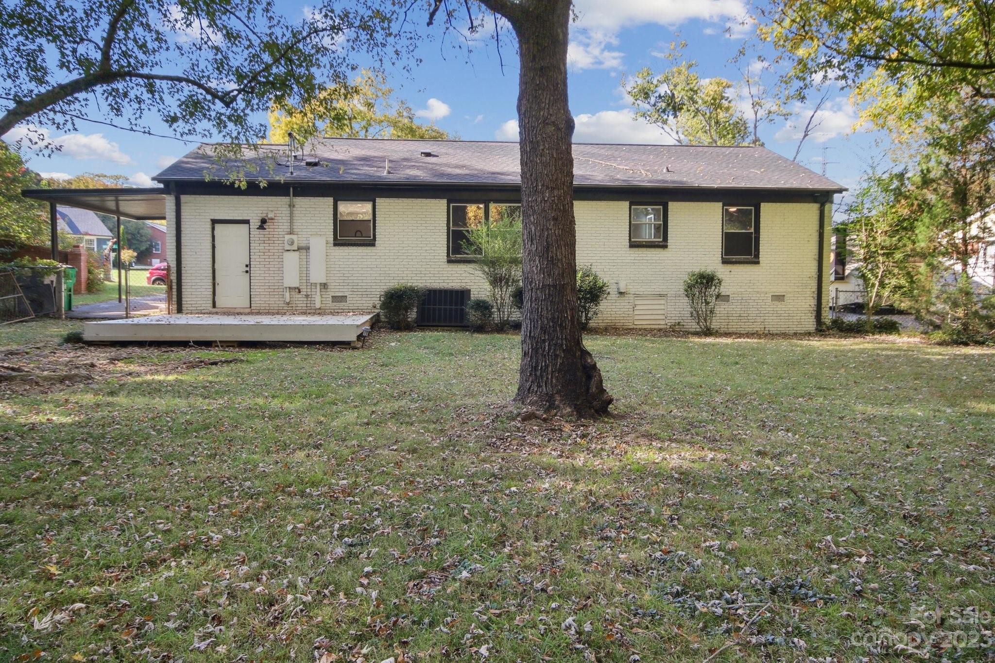 5225 Farmbrook Drive Charlotte, NC 28210 - Photo 17 of 18 a front view of a house with a garden and yard