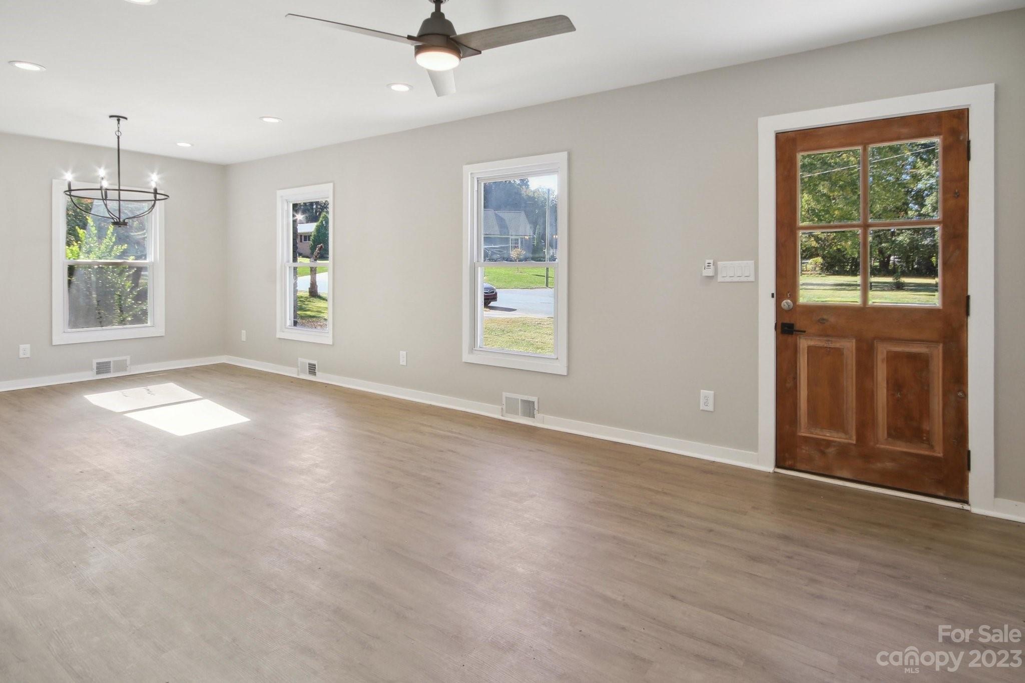 5225 Farmbrook Drive Charlotte, NC 28210 - Photo 2 of 18 an empty room with wooden floor and windows