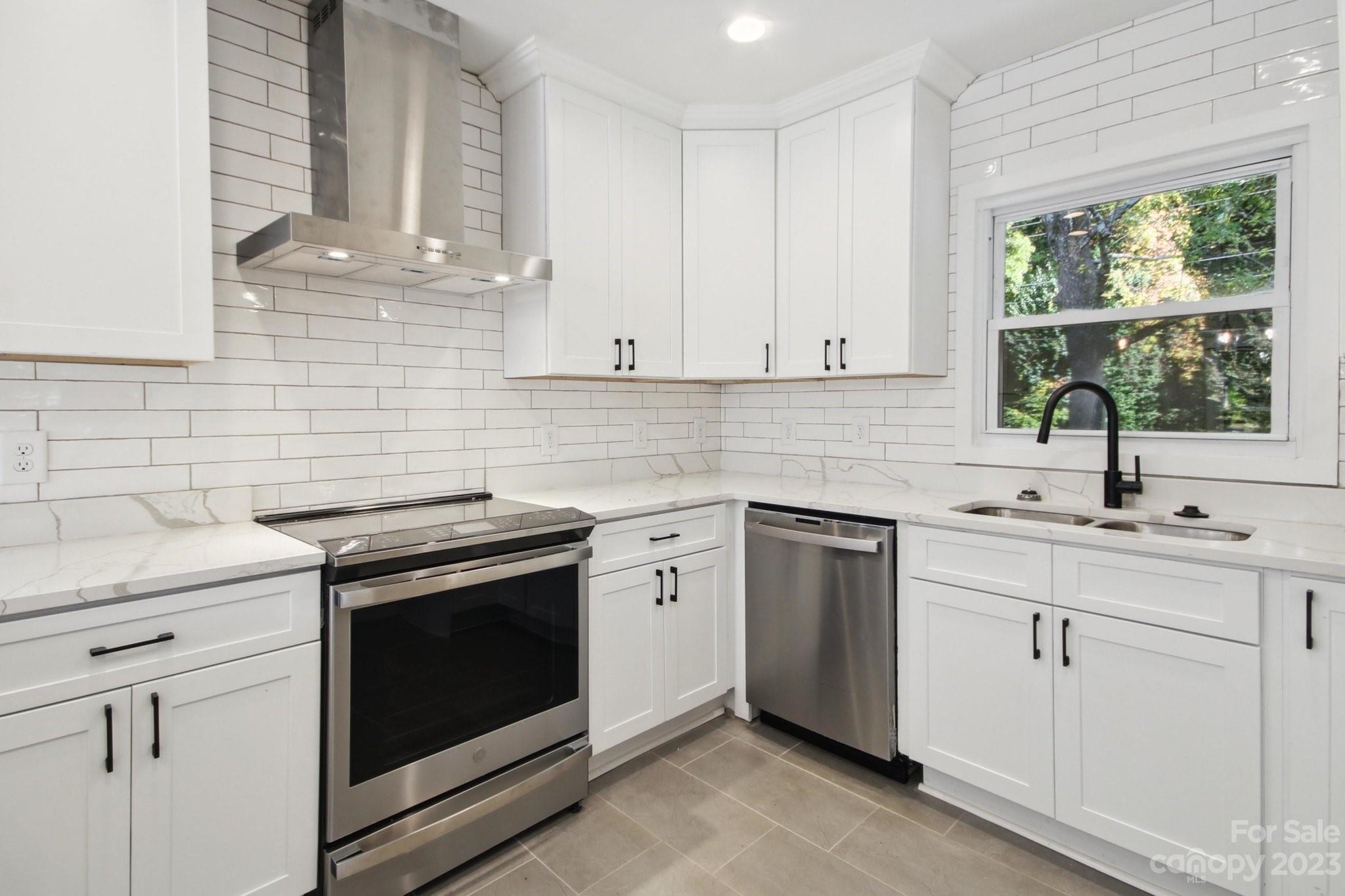 5225 Farmbrook Drive Charlotte, NC 28210 - Photo 5 of 18 a kitchen with white cabinets appliances and a sink