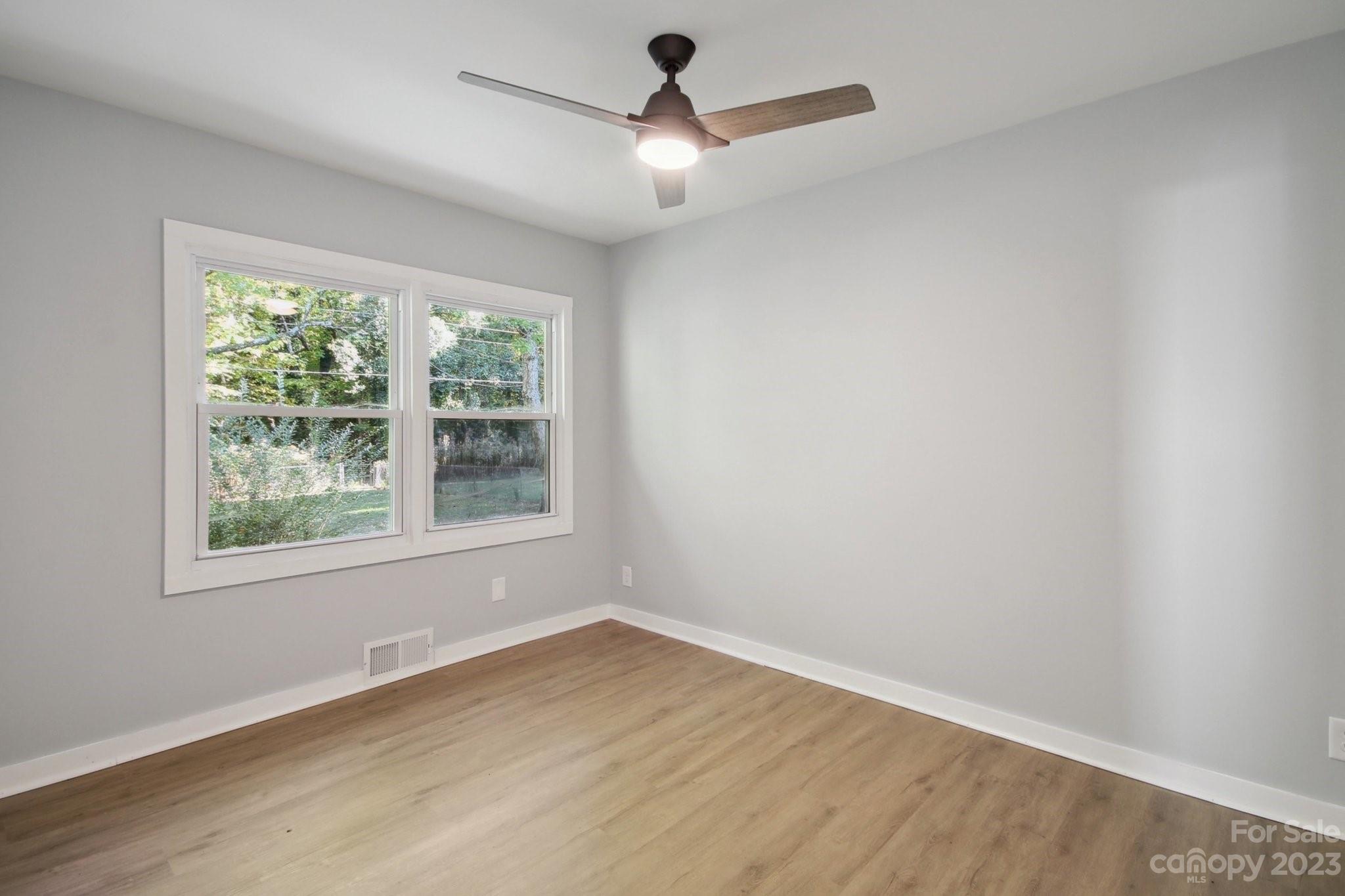 5225 Farmbrook Drive Charlotte, NC 28210 - Photo 10 of 18 an empty room with wooden floor and windows