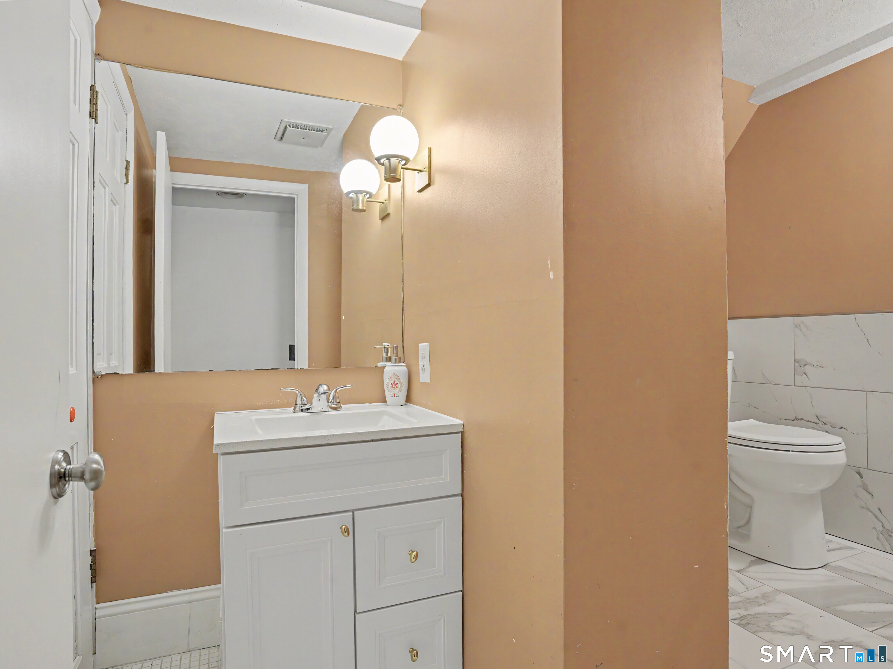 15 Flat Rock Drive Ridgefield, CT 06877 - Photo 36 of 39 a bathroom with a sink a toilet and mirror