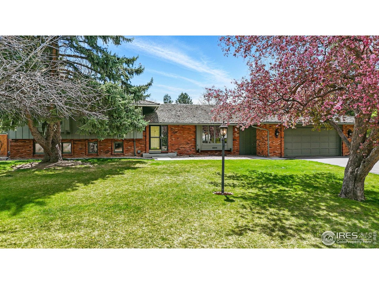 6844 Roaring Fork Trail Boulder, CO 80301 - Photo 1 of 37 a house view with a garden space