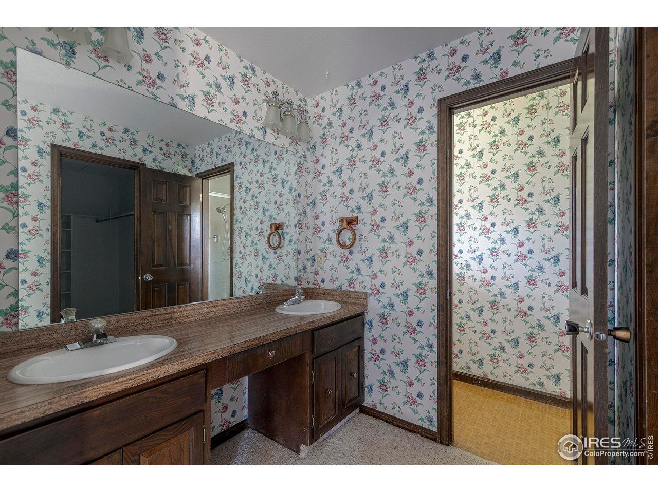 6844 Roaring Fork Trail Boulder, CO 80301 - Photo 15 of 37 a bathroom with a granite countertop sink a mirror and a shower