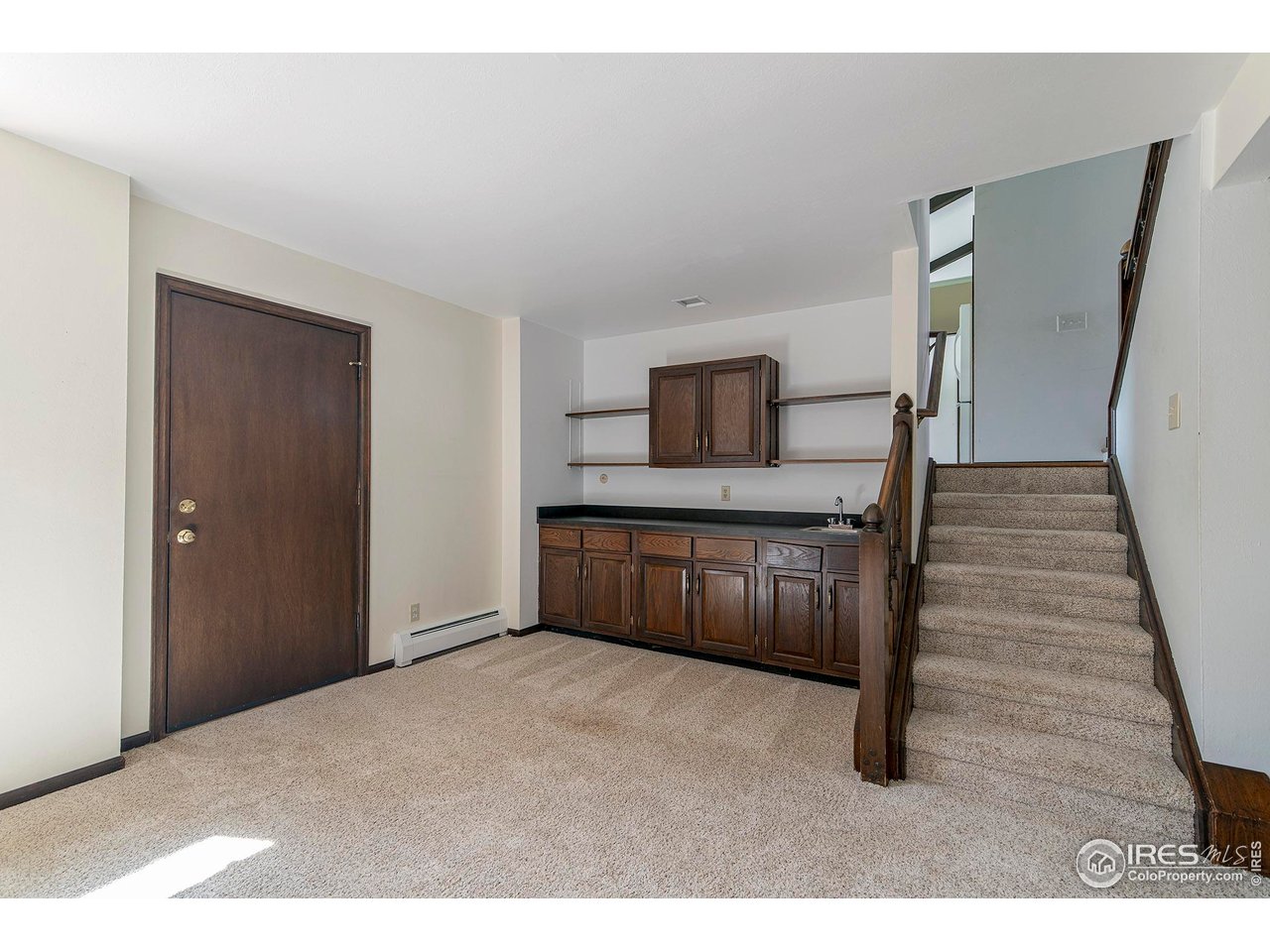6844 Roaring Fork Trail Boulder, CO 80301 - Photo 19 of 37 a kitchen with cabinets and wooden floor