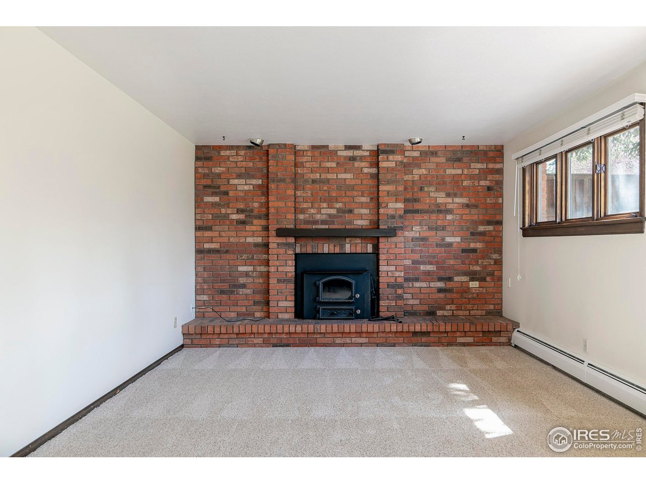 6844 Roaring Fork Trail Boulder, CO 80301 - Photo 22 of 37 a view of an empty room with a fireplace
